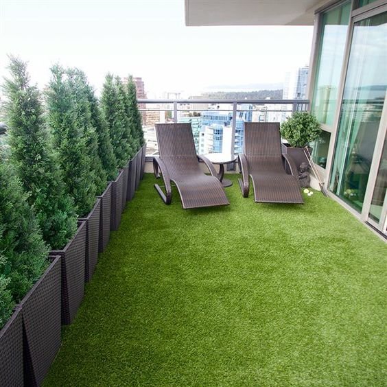 balcony artificial grass, potted plants, and lounge chairs