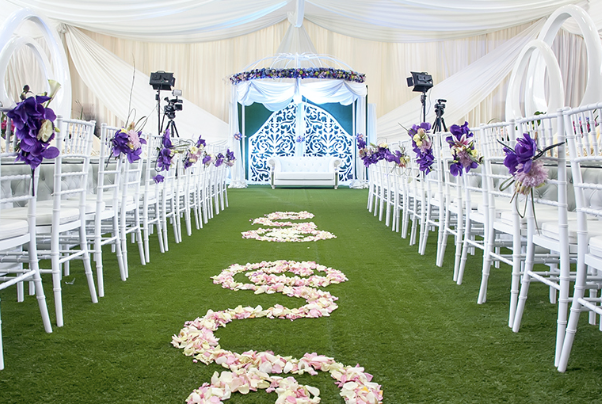 Wedding Ceremony Setup with White Chairs and Green event Turf