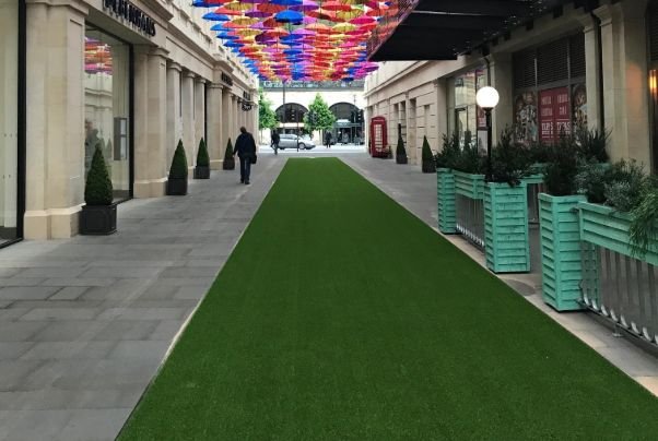 Colorful Umbrella Canopy Over Green Event turf Path